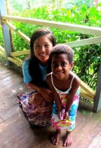 student posing with little girl from fiji