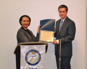 man and woman posing with award