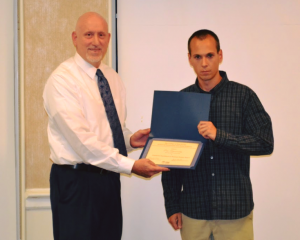 two men posing with award