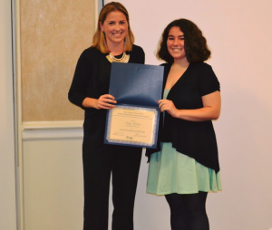 two women posing with award