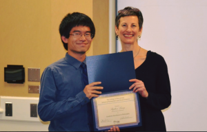 man and woman posing with award