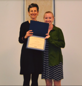 two women posing with award