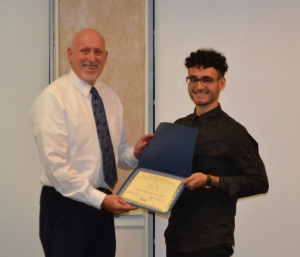 two men posing with award